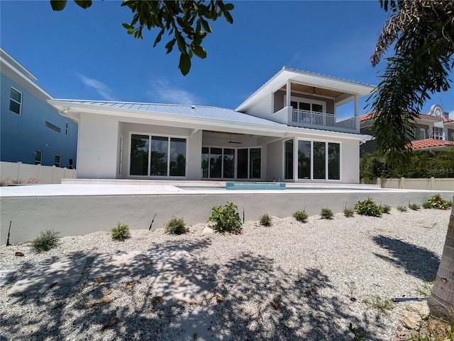 rear view of house featuring a patio, a balcony, ceiling fan, and a fenced in pool