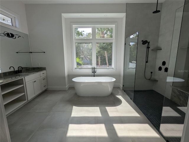 4819 Higel Rd, Sarasota, FL 34242 - full bath with walk in shower, a freestanding tub, vanity, baseboards, and tile patterned floors