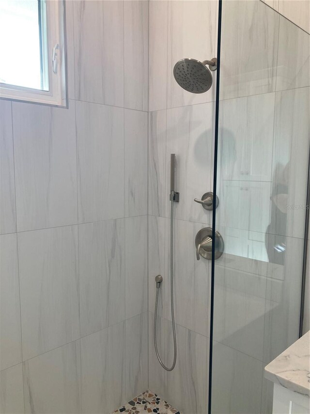 bathroom with a tile shower