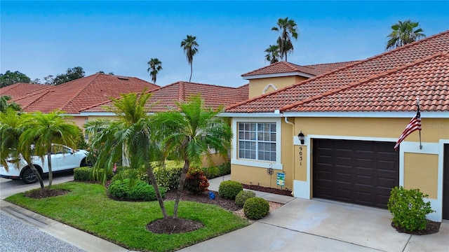 mediterranean / spanish-style house with a garage