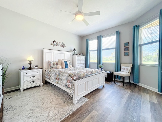 bedroom with ceiling fan and wood-type flooring