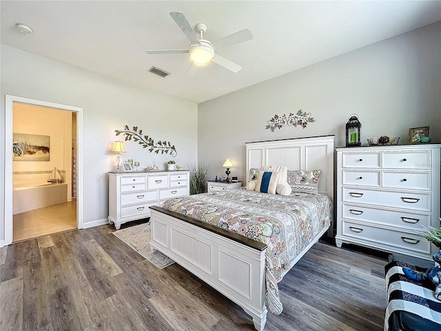 bedroom featuring ceiling fan, connected bathroom, and dark hardwood / wood-style floors