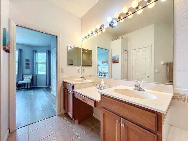 bathroom featuring hardwood / wood-style flooring and dual bowl vanity