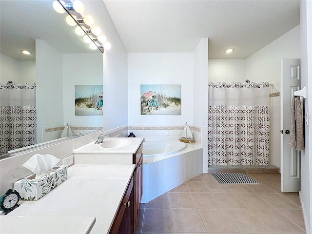 bathroom with tiled bath, vanity, and tile patterned floors