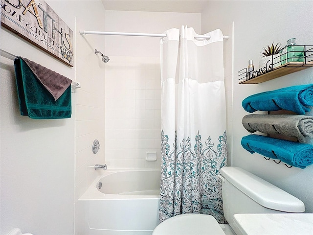 bathroom featuring shower / bath combo with shower curtain and toilet