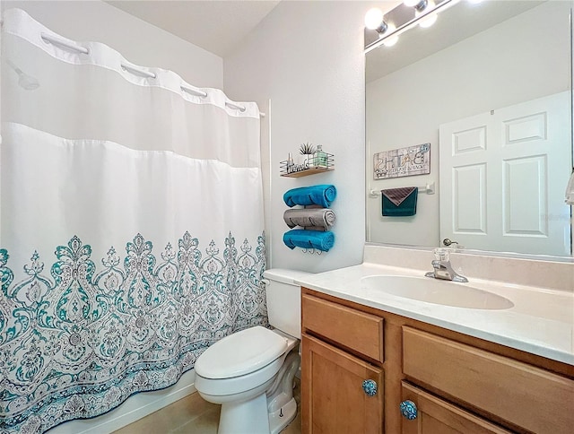 bathroom with tile patterned flooring, toilet, and vanity