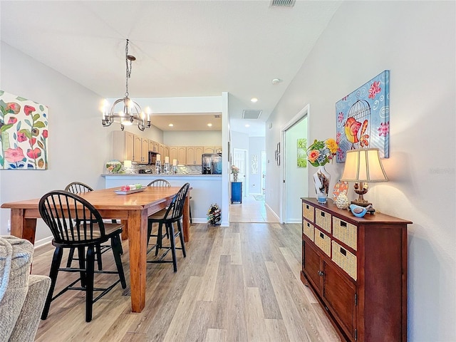 dining room featuring a notable chandelier and light hardwood / wood-style floors