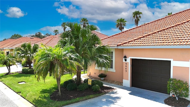 mediterranean / spanish-style home with a garage and a front lawn