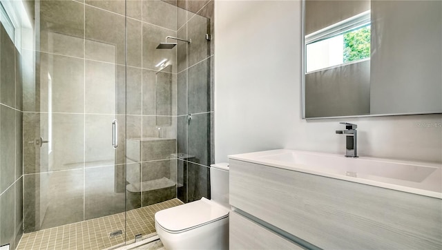 bathroom with a shower with shower door, toilet, and vanity