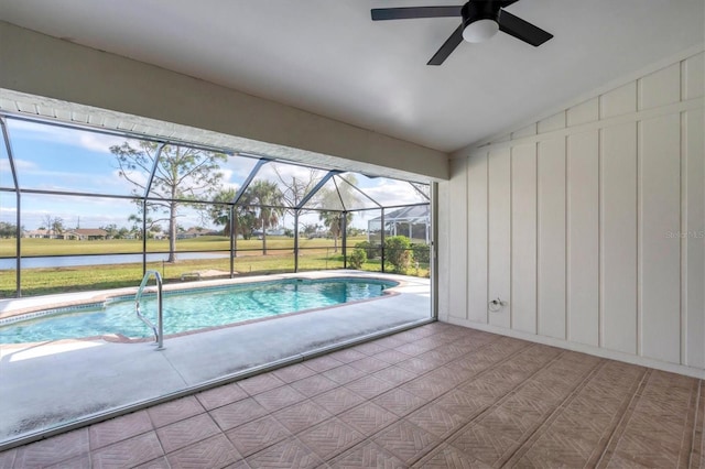 view of swimming pool featuring glass enclosure, ceiling fan, and a patio