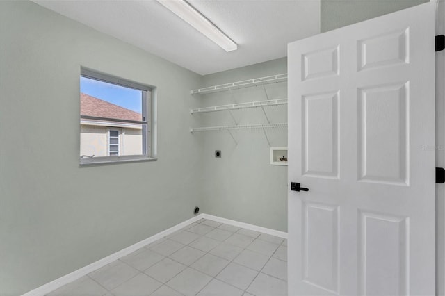 washroom featuring hookup for a washing machine, light tile patterned flooring, and hookup for an electric dryer