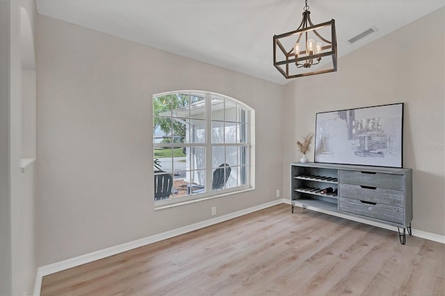 interior space with an inviting chandelier and hardwood / wood-style flooring