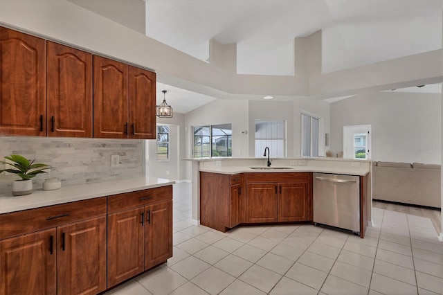 kitchen with light tile patterned floors, dishwasher, backsplash, and sink