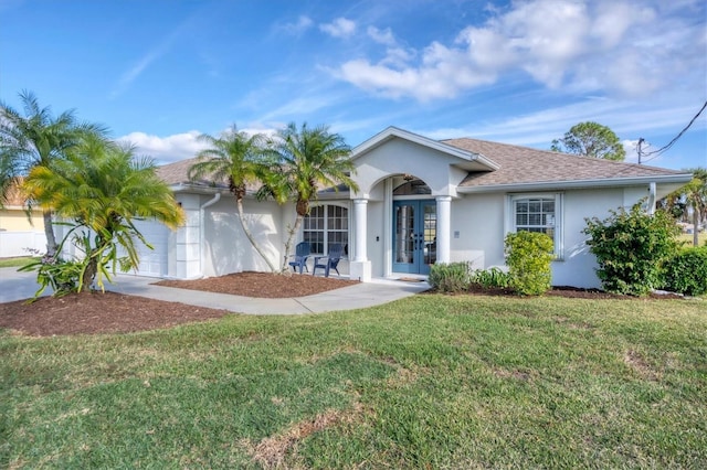 single story home featuring a front lawn, french doors, and a garage