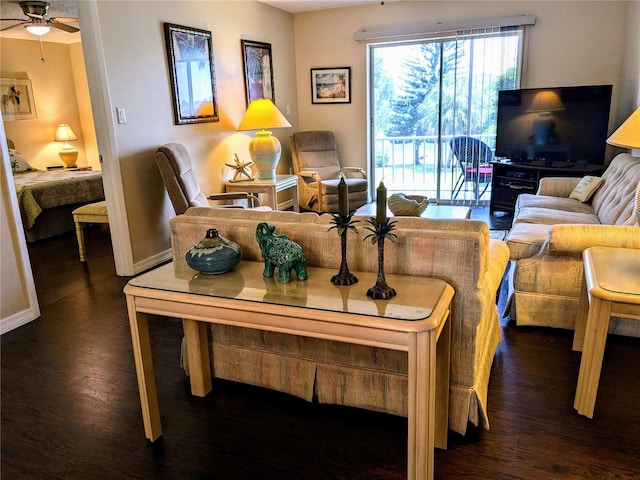 living room with ceiling fan and dark wood-type flooring