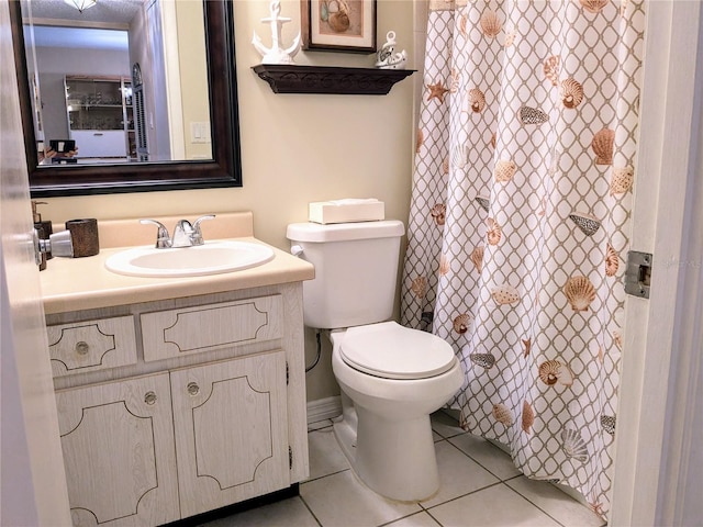 bathroom with tile patterned floors, vanity, and toilet