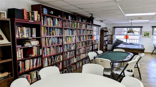 interior space with a paneled ceiling