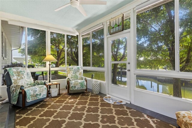 sunroom with a healthy amount of sunlight and ceiling fan