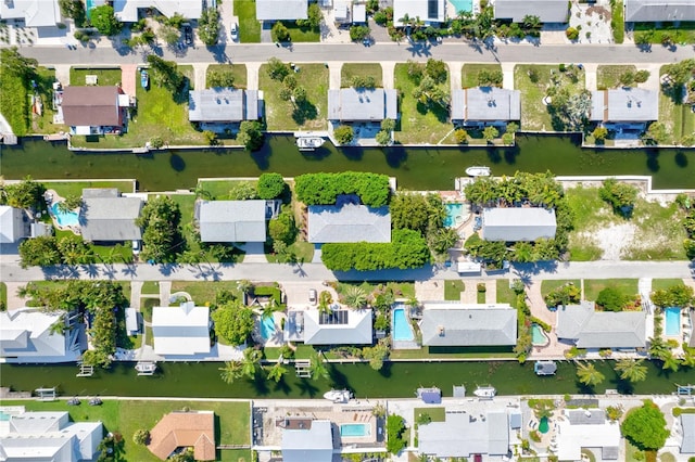 birds eye view of property with a water view and a residential view