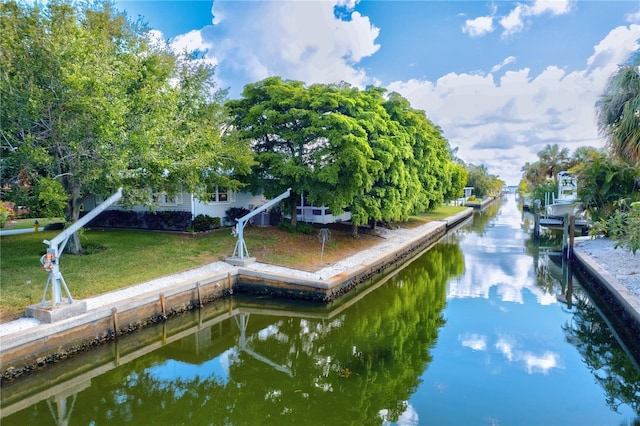 view of property's community featuring a yard and a water view