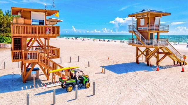 view of playground with a beach view and a water view