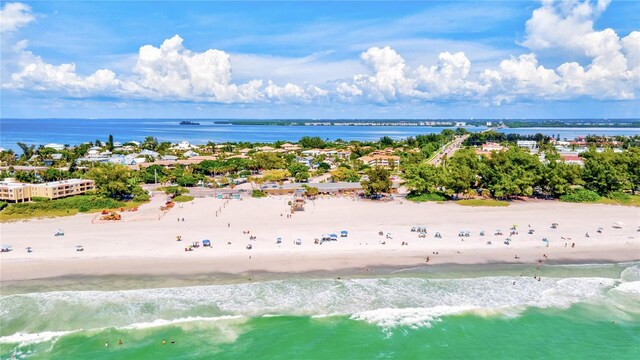 drone / aerial view featuring a water view and a beach view