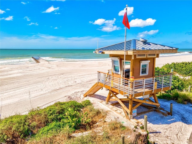 surrounding community featuring a water view and a view of the beach