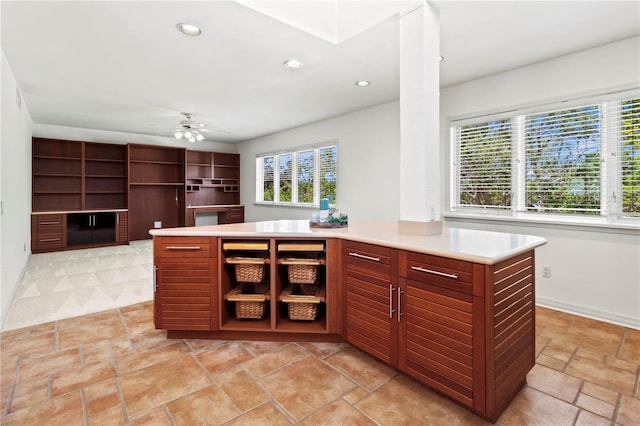 kitchen featuring ceiling fan and a center island