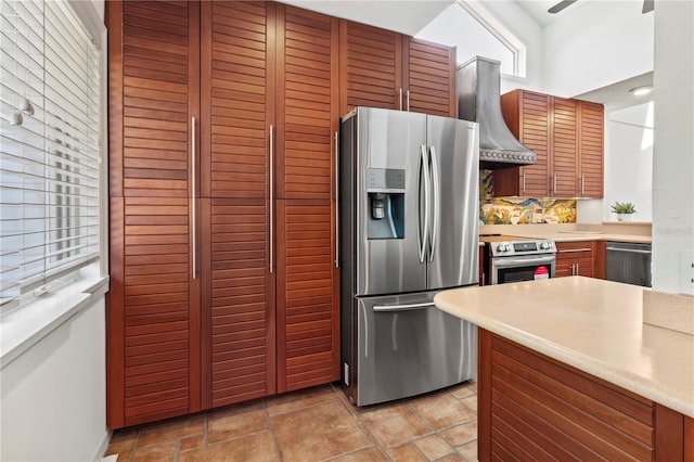 kitchen featuring appliances with stainless steel finishes, backsplash, ventilation hood, and ceiling fan