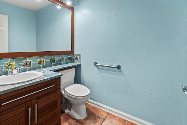 bathroom with backsplash, tile patterned floors, vanity, and toilet