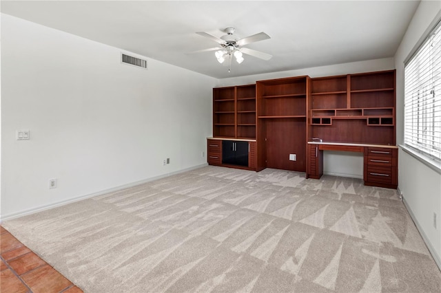 unfurnished living room with ceiling fan and light carpet