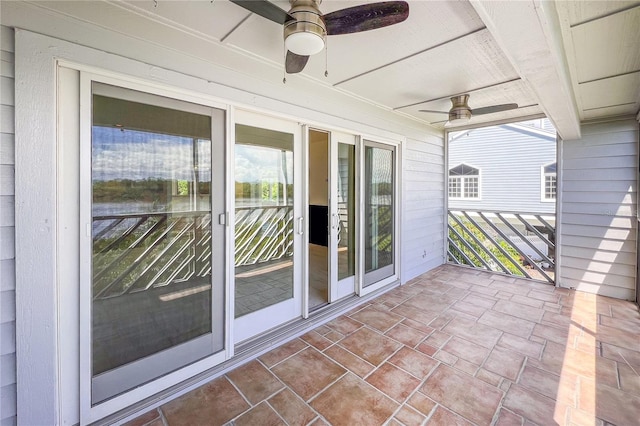 exterior space featuring ceiling fan and a wealth of natural light