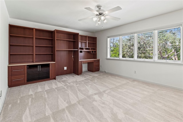 unfurnished living room featuring ceiling fan and light colored carpet