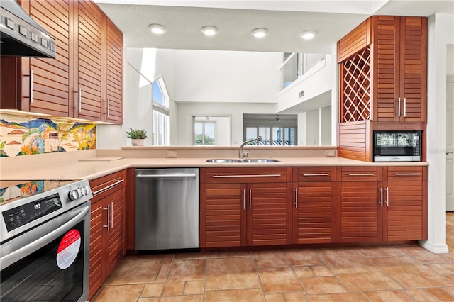 kitchen with exhaust hood, stainless steel appliances, and sink