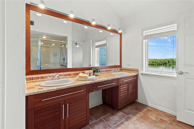 bathroom with vanity, walk in shower, and lofted ceiling