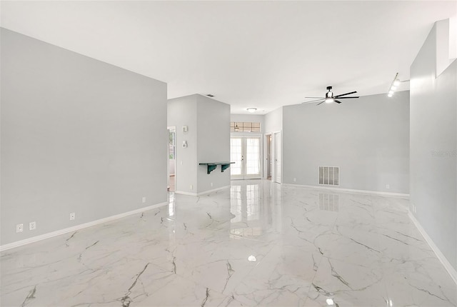 spare room with marble finish floor, french doors, visible vents, and baseboards