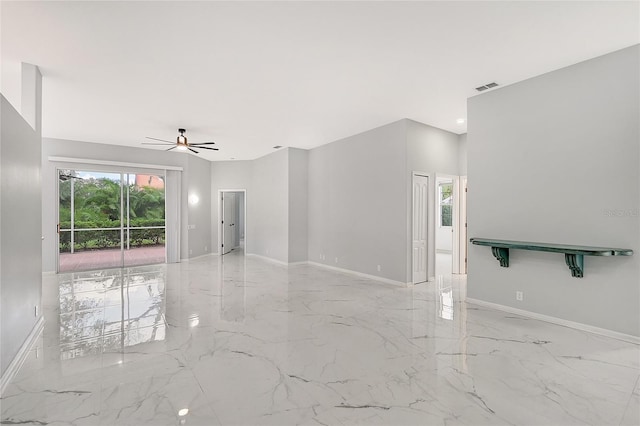 unfurnished room featuring a ceiling fan, marble finish floor, visible vents, and baseboards