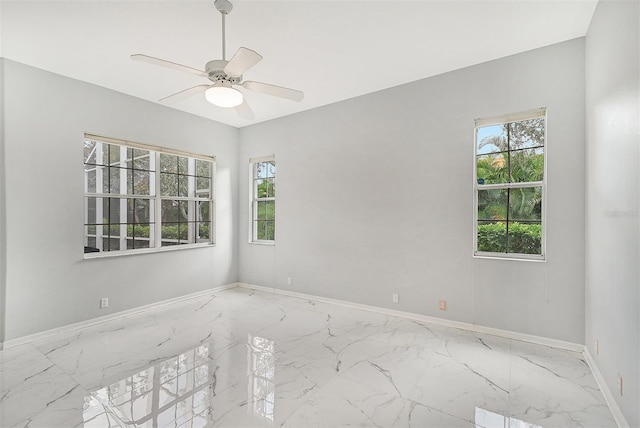 tiled empty room featuring ceiling fan