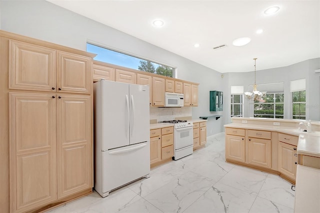 kitchen with light tile patterned floors, a wealth of natural light, white appliances, and light brown cabinetry