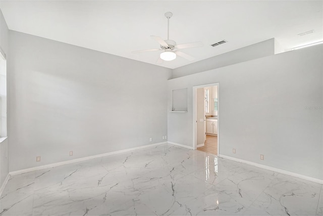 unfurnished bedroom featuring marble finish floor, visible vents, ceiling fan, and baseboards