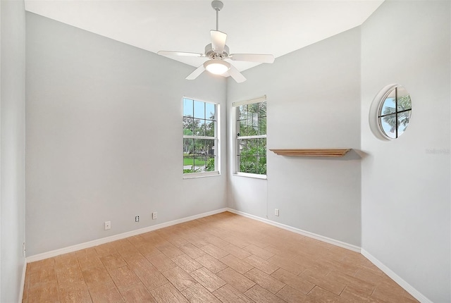 unfurnished room with light wood-type flooring, ceiling fan, and baseboards