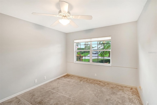 carpeted empty room featuring ceiling fan