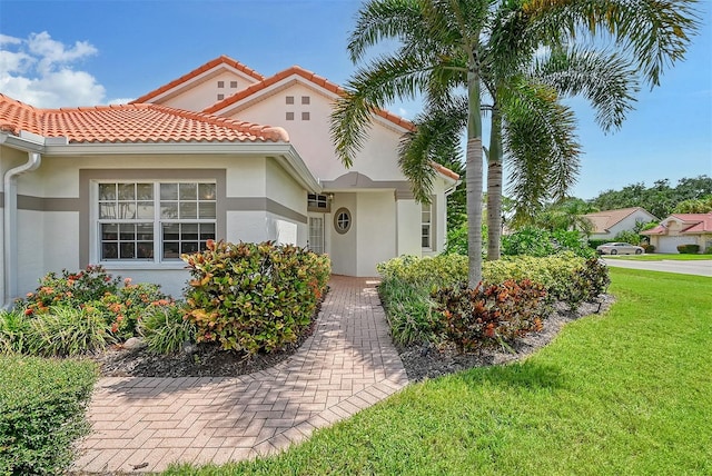 mediterranean / spanish home with a front yard