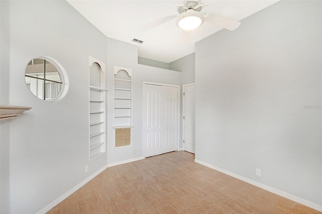 unfurnished bedroom with light wood finished floors, baseboards, visible vents, ceiling fan, and a closet