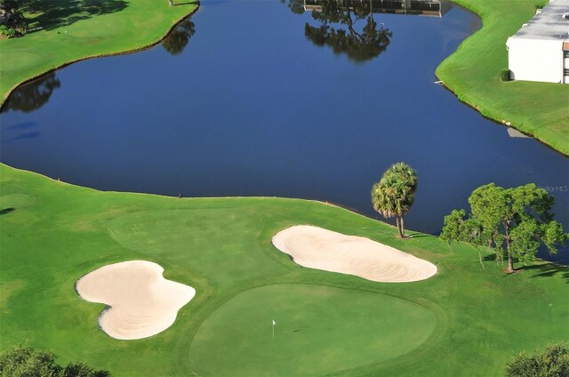 birds eye view of property featuring view of golf course and a water view