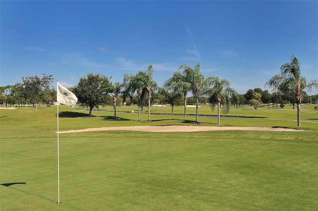 view of home's community with a yard and golf course view