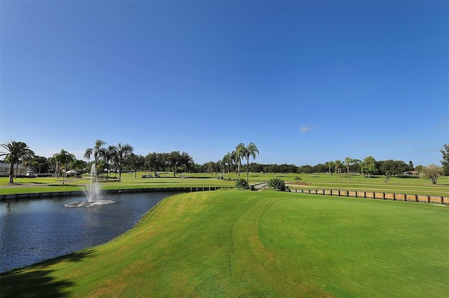 surrounding community with a lawn and a water view