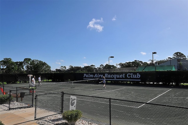 view of tennis court with fence