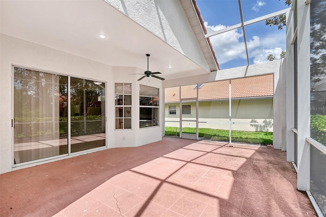 unfurnished sunroom with ceiling fan