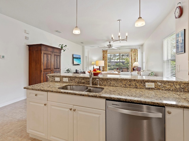 kitchen with sink, stainless steel dishwasher, light stone counters, and light tile patterned floors